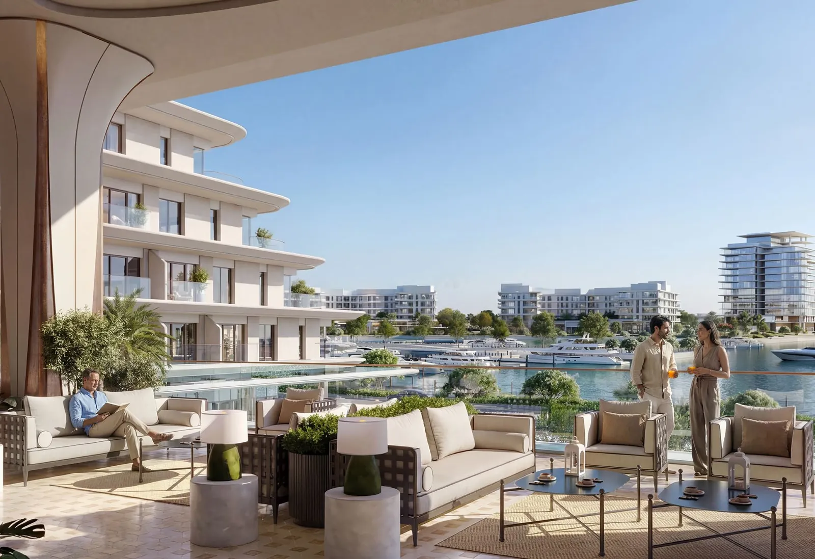 Covered terrace with sofas and a dining table looking over the marina to the island’s residences